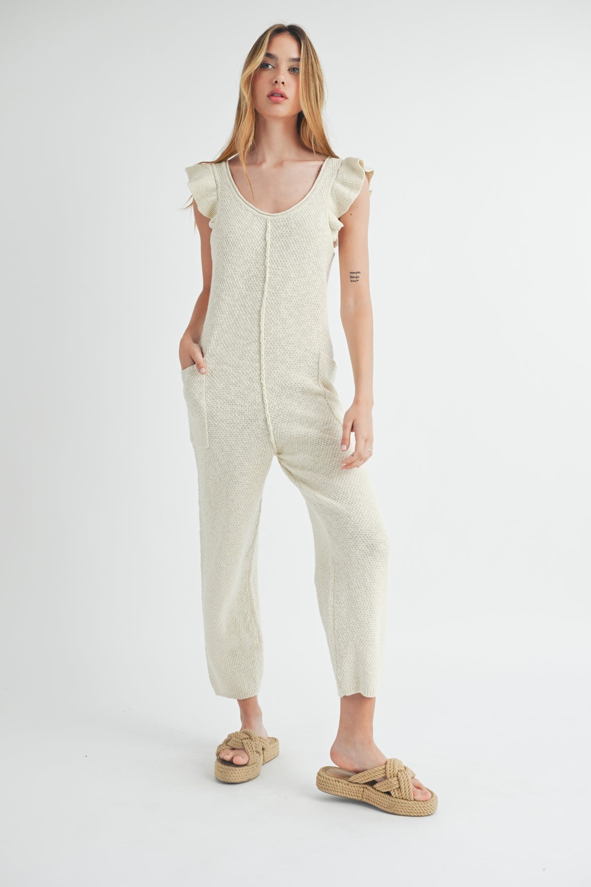 KNIT JUMPSUIT WITH RUFFLE SLEEVE